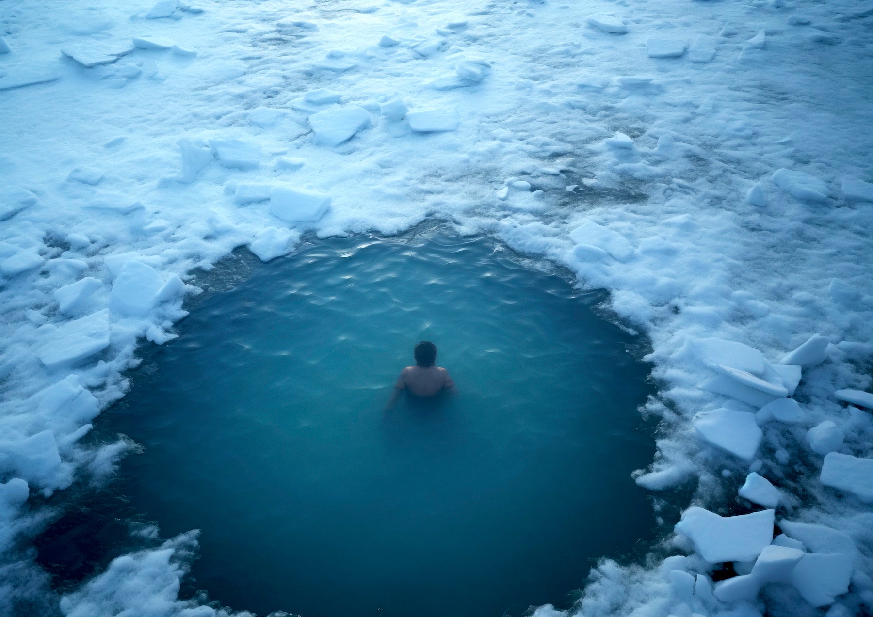 This image showcases Cold Plunge, a practice of cold water therapy. It features a man standing in a pool filled with icy water up to his waist, wearing swimwear. The image represents the refreshing and energizing effects of this cold immersion.